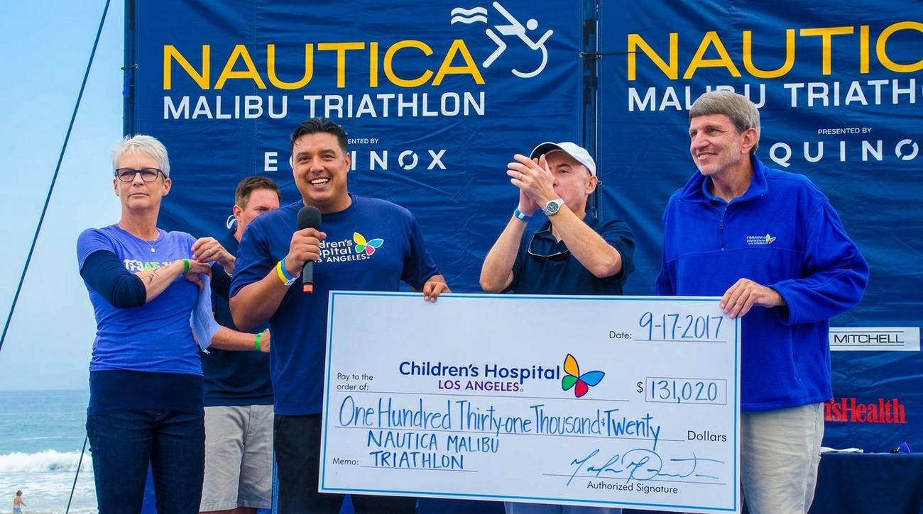 Marlon presenting $131,020 check to CHLA at Nautica Malibu Triathlon fundraiser