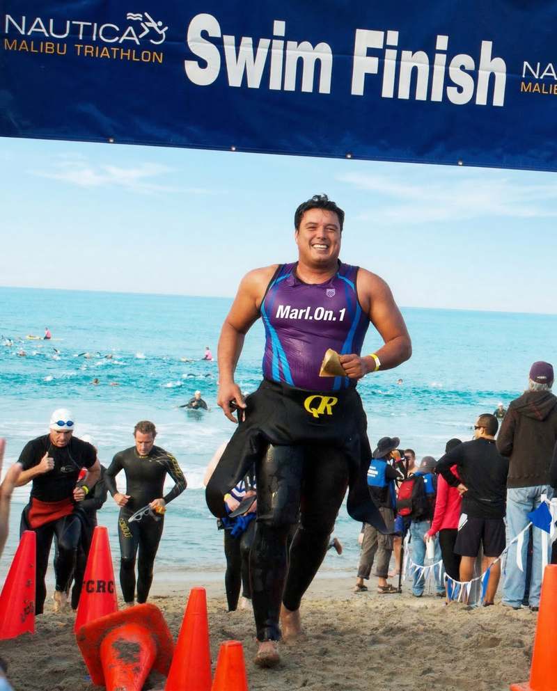 Marlon Duarte crossing the Malibu Triathlon swim finish in Marl.On.1 jersey