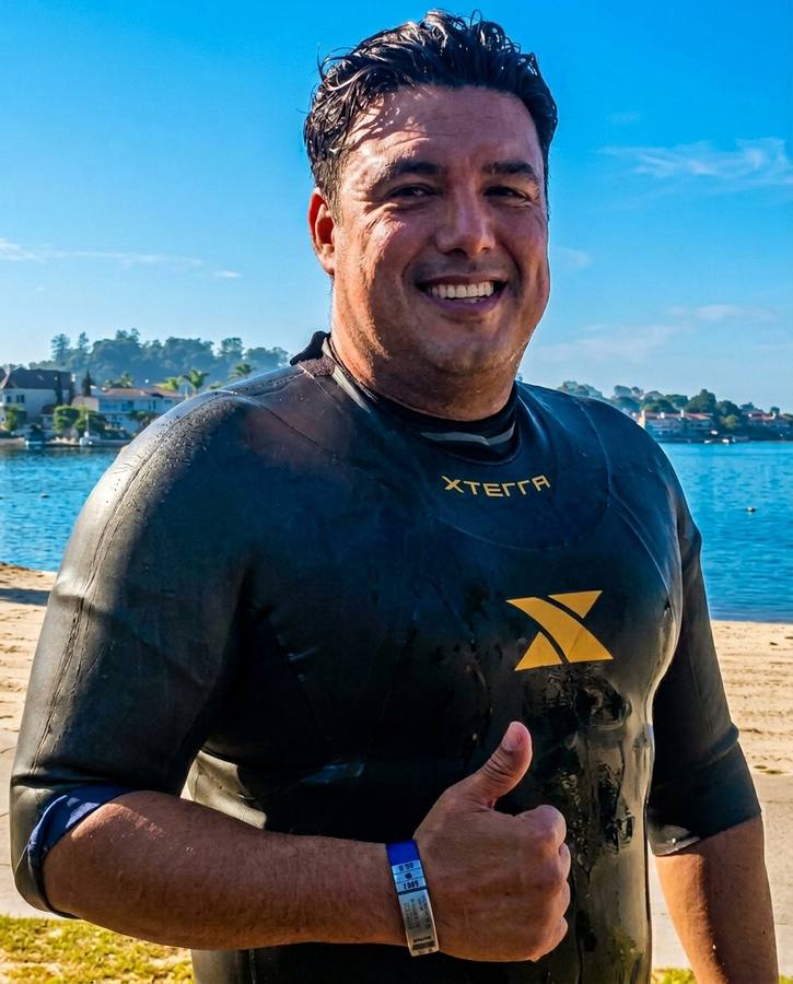 Marlon after 2 mile swim giving thumbs up in XTERRA wetsuit