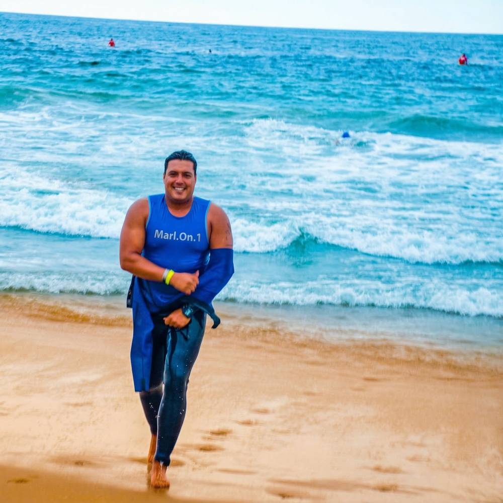Marlon Duarte coming out of ocean in Marl.On.1 jersey on the beach
