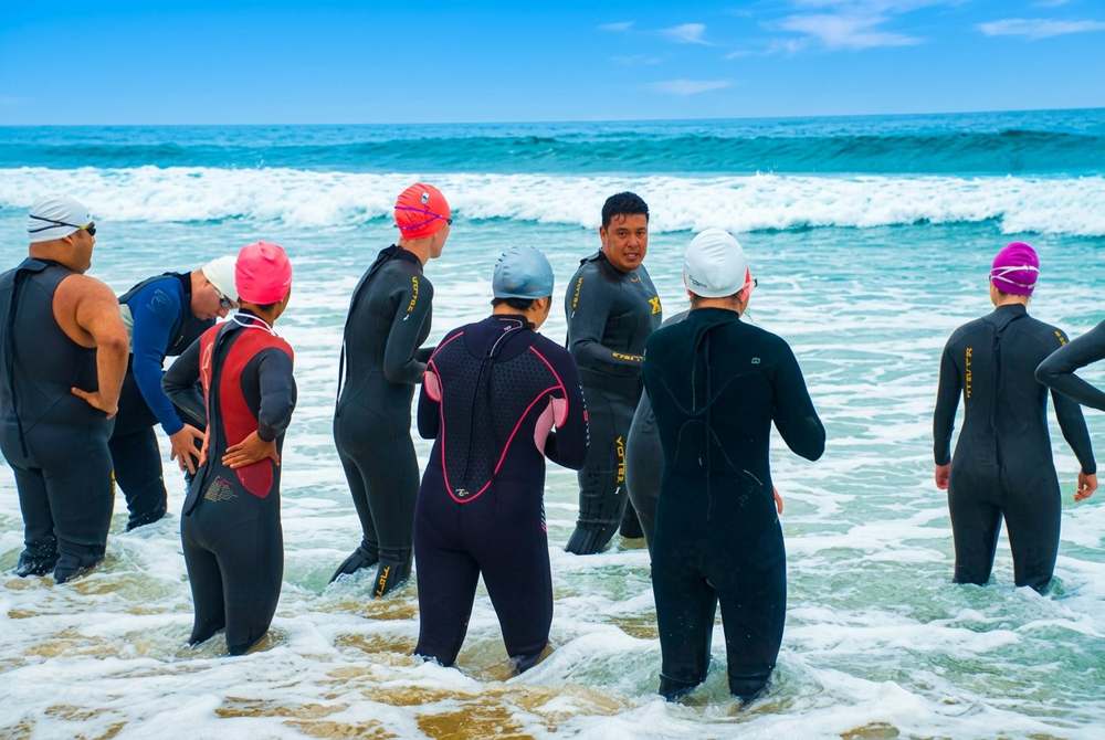 Marlon coaching group ocean swim session at Zuma Beach, Malibu