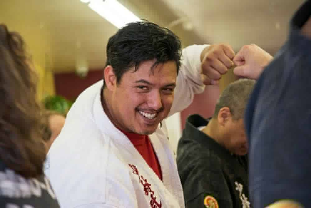 Marlon smiling mid-technique in Kung Fu class